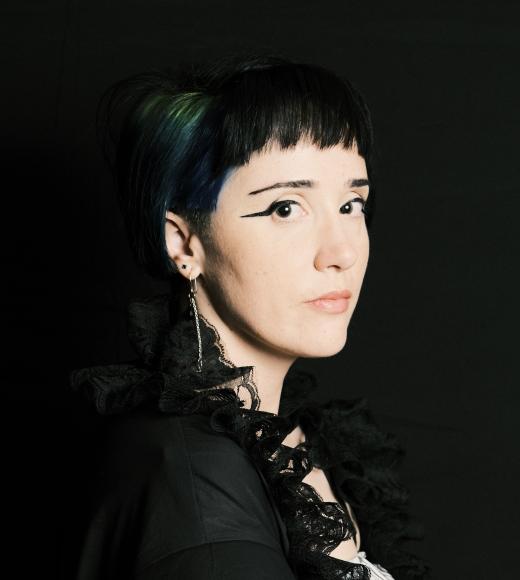 Jessica Bond is shown with black hair against a black background.