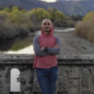 Beshara Kehdi stands in a red vest in front of a waterway.